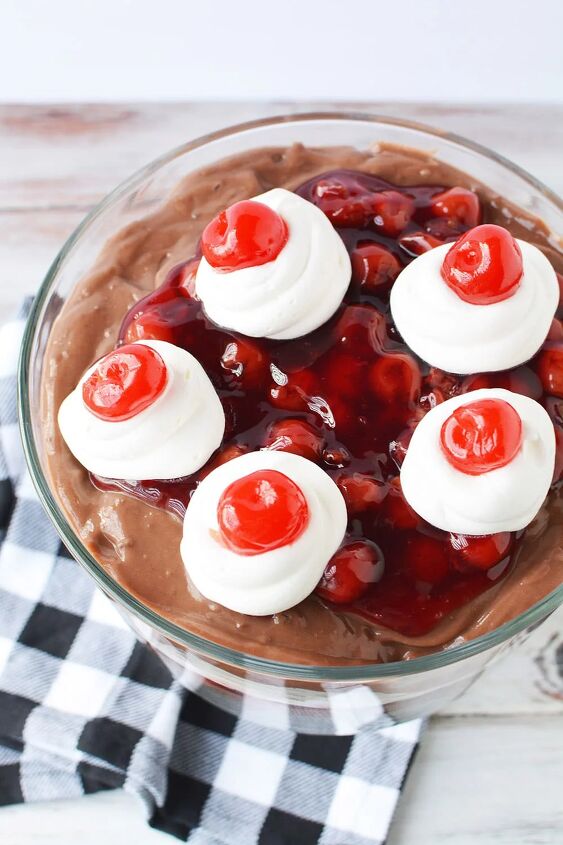 chocolate cherry black forest trifle, Top of a chocolate cherry trifle with cherries on top of whipped cream