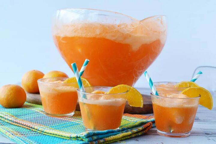 easy orange sherbet punch recipe, Cups of orange punch in front of large punch bowl filled with orange sherbet punch