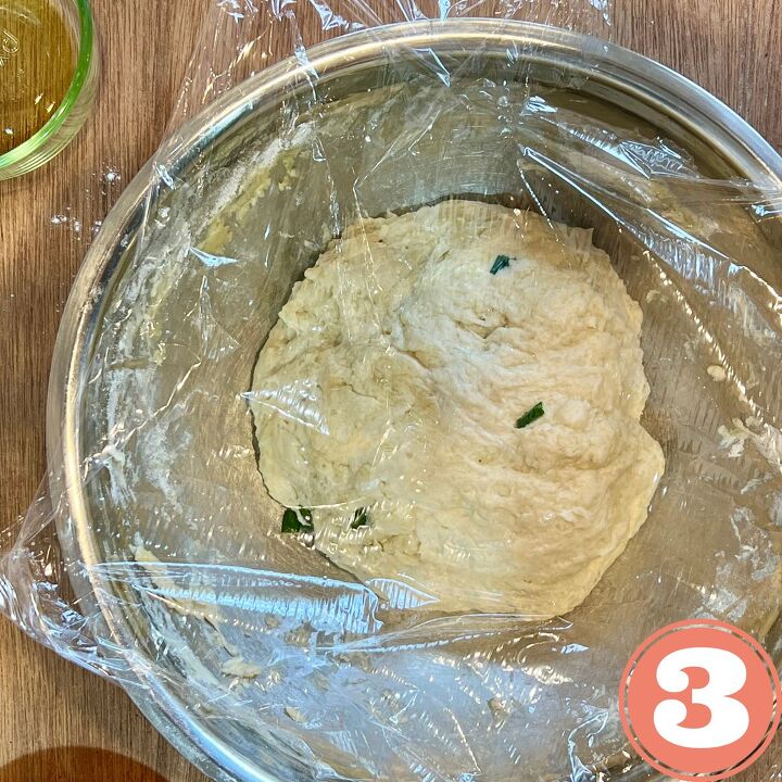 easy vegan flour tortillas using a press, Tortilla dough covered with Saran Wrap in a stainless steel bowl