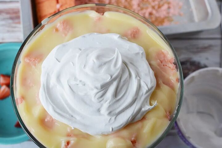 irresistible strawberry cheesecake trifle recipe, Large dollop of whipped cream on top of pudding