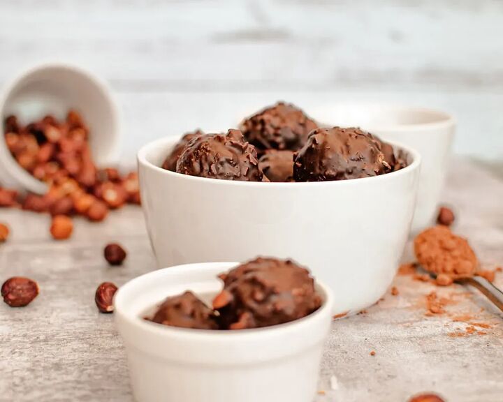 homemade chocolate coconut date balls, Date balls in a bowl with hazelnuts and other ingredients
