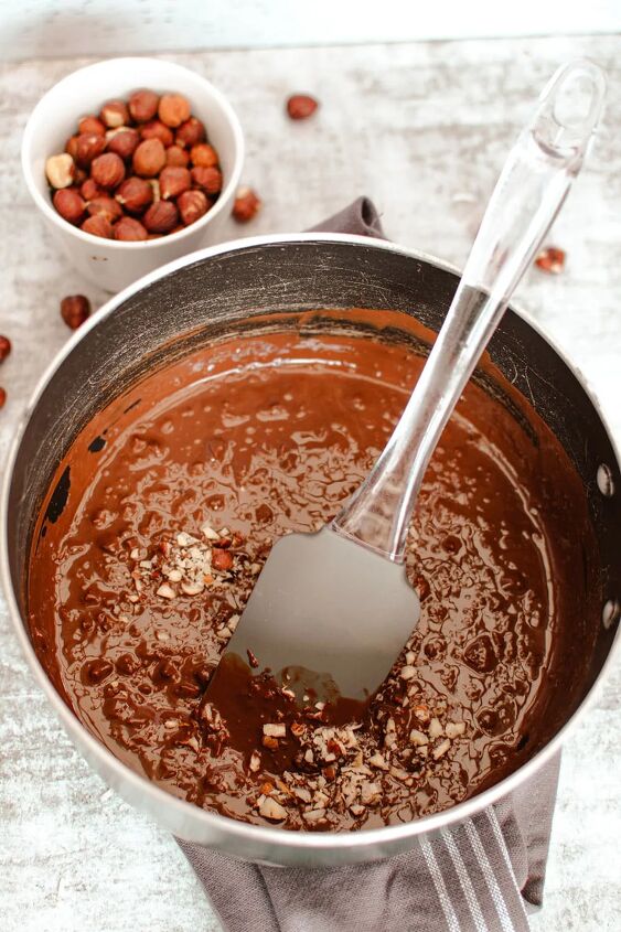homemade chocolate coconut date balls, Stirring melted chocolate and coconut in a pan