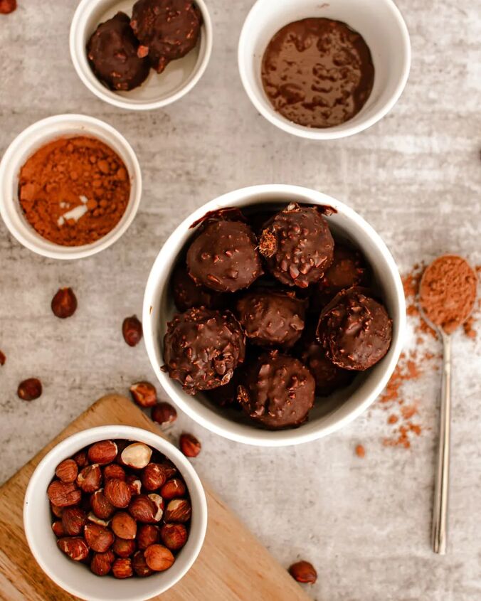 homemade chocolate coconut date balls, Overhead image of date balls and bowls of hazelnuts and other ingredients