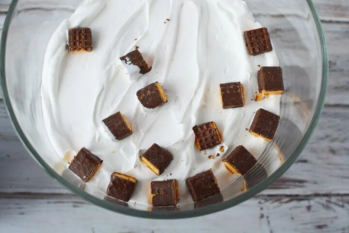 chocolaty chocolate trifle recipe, Pieces of fudge sticks on top of whipped cream in a trifle