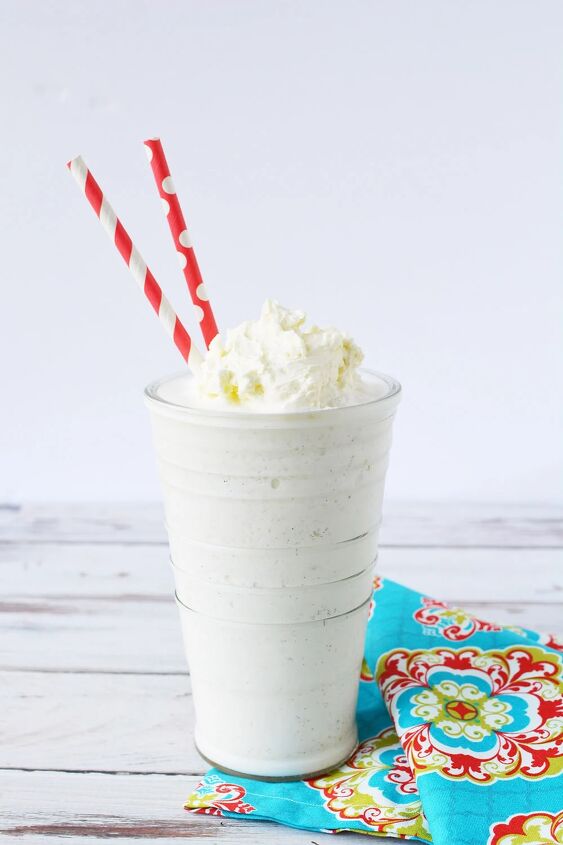 icy and refreshing vanilla bean frappuccino, Vanilla bean frappuccino topped with whipped cream in a glass