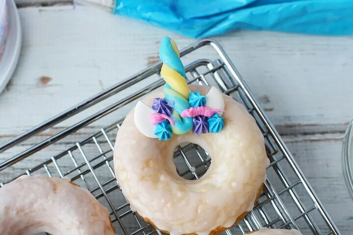 baked unicorn donut recipe with candy horns, Donut on a rack with frosting and candy horn and ears