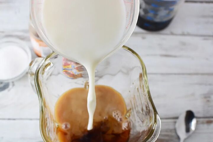 icy and creamy caramel frappuccino recipe, Pouring milk into a blender that has coffee in it
