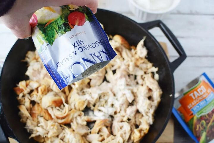 easy and flavorful chicken ranch tacos, Dumping a packet of ranch dressing mix into shredded chicken