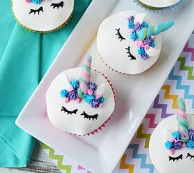 adorable unicorn cupcakes with horns and eyes, Unicorn cupcakes with faces and horns on a table