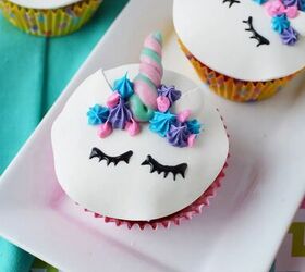 adorable unicorn cupcakes with horns and eyes, Unicorn cupcakes with eyes ears and horns sitting on a tray on a table