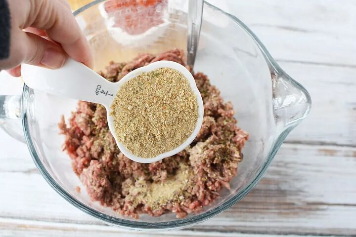 easy cheese stuffed meatloaf comfort food recipe, Adding 1 4 cup of bread crumbs into ground beef