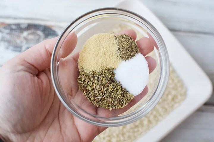 easy parmesan crusted chicken recipe, Holding seasonings in a bowl above bread crumbs