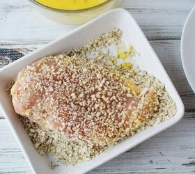 easy parmesan crusted chicken recipe, Chicken coated with bread crumbs in a dish