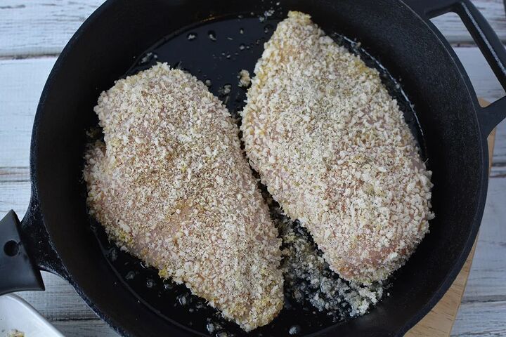 easy parmesan crusted chicken recipe, Parmesan crusted chicken breasts in a skillet frying
