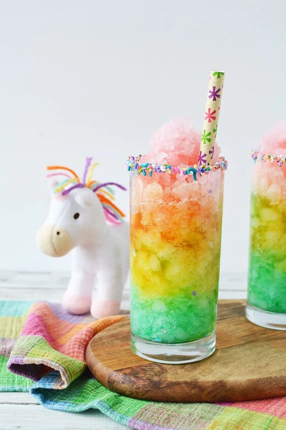rainbow unicorn slush icy lemonade, Rainbow slush next to a unicorn plush toy