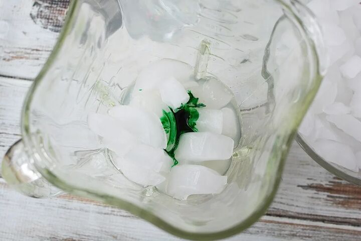 rainbow unicorn slush icy lemonade, Green food coloring on top of ice in a blender