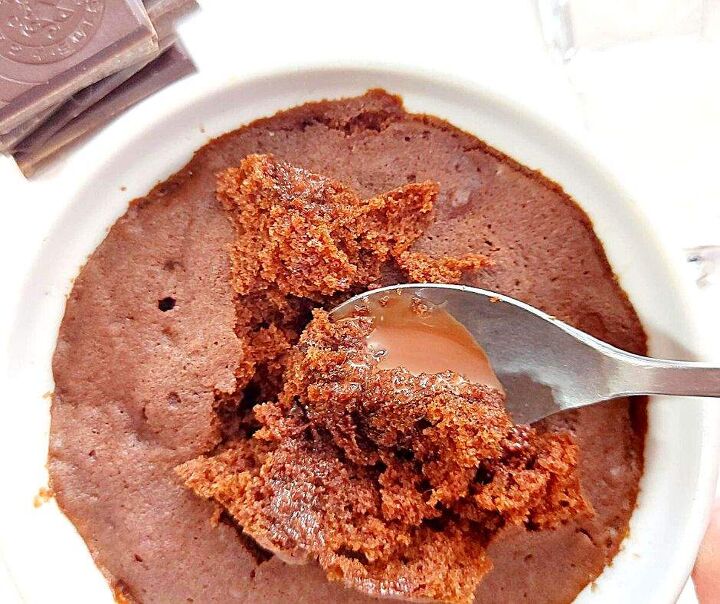 gooey chocolate mug cake that chocolate lovers need in their life, Gooey chocolate mug cake with a stack of chocolate squares on the side