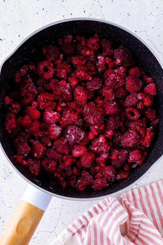how to make raspberry compote, Toss the raspberries in sugar and lemon juice