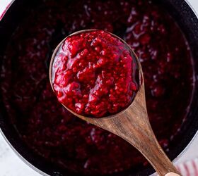how to make raspberry compote, A saucepan and wooden spoon filled with compote