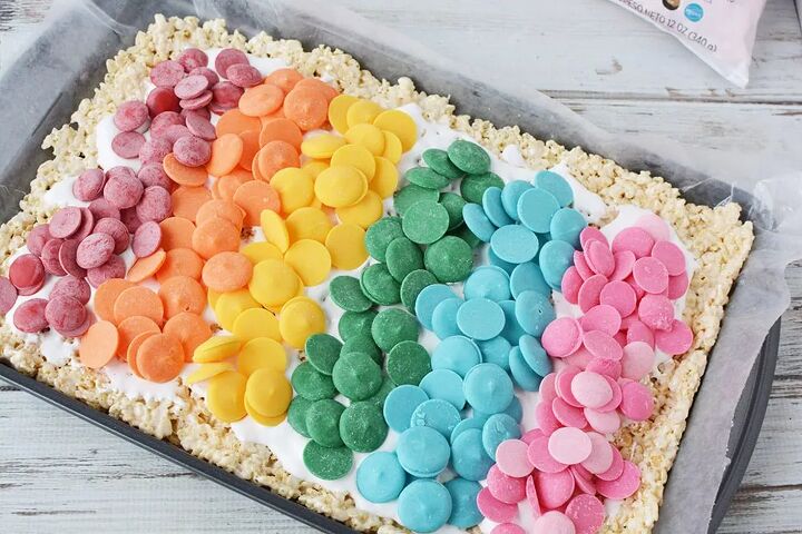 rainbow pinwheel rice krispies treats recipe, Rainbow of candy melts on top of rice cereal in a baking sheet