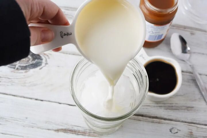 easy homemade iced caramel macchiato recipe, Pouring milk into tumbler