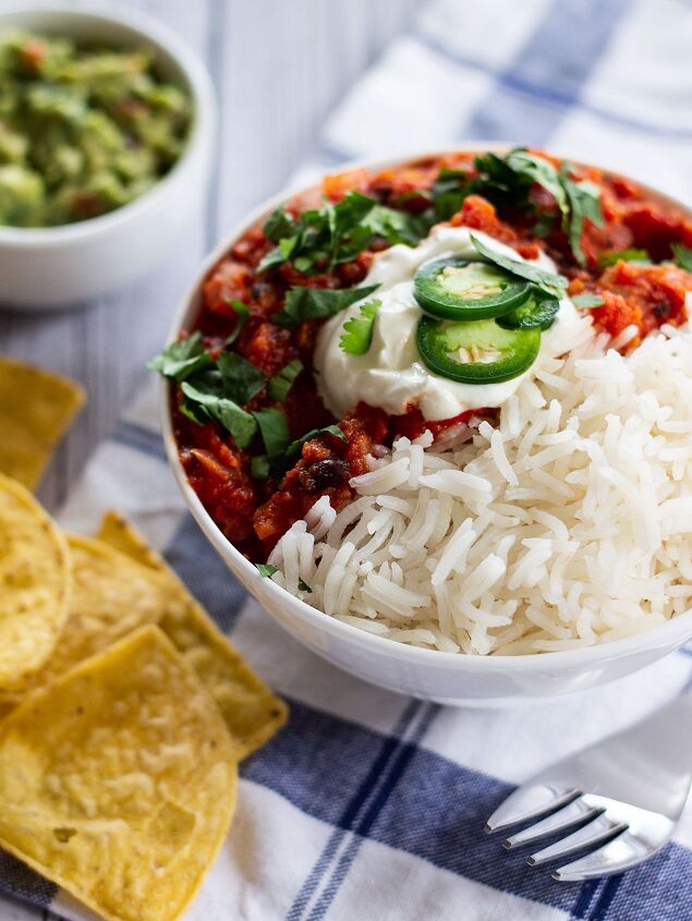 easy spicy mexican chilli bean soup with corn, a bowl of chilli served with guacamole and tortilla chips