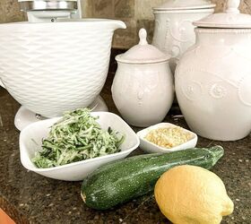 the best lemon zucchini bread, mixing bowl and white canisters on counter with lemon zucchini bowl of shredded zucchini and grated lemon zest