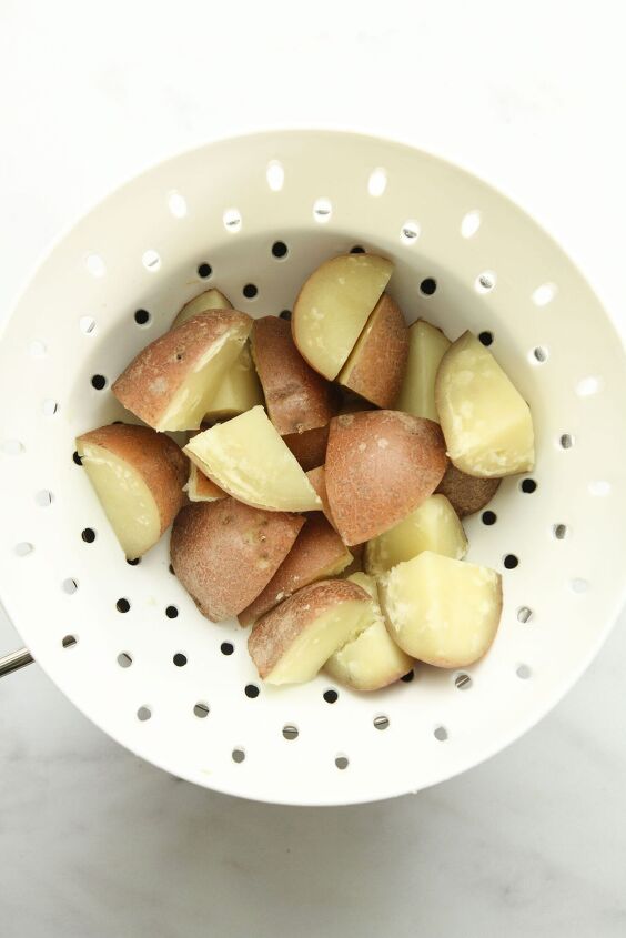 the best easy creamy red skin potato salad no egg, The cooked potatoes in a white sieve