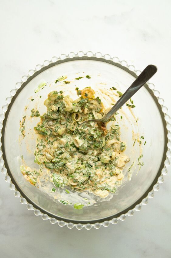 the best easy creamy red skin potato salad no egg, The dressing with scallions capers parsley and chives in a glass bowl