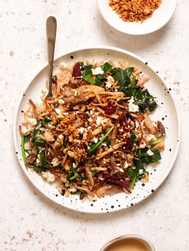 the best easy creamy red skin potato salad no egg, warm mushroom salad served on a plate with crunchy onions and dressing on the side