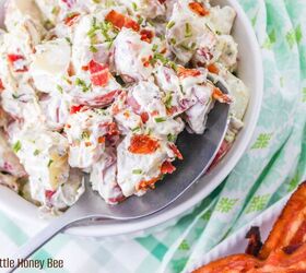 bacon ranch potato salad, Aerial view of potato salad in a white bowl with a spoon resting in it