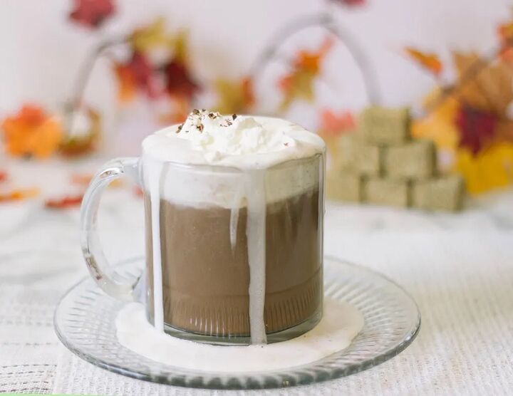 easy and delicious low carb hot chocolate recipe, Low carb hot chocolate with whipped cream next to fall decorations on a table