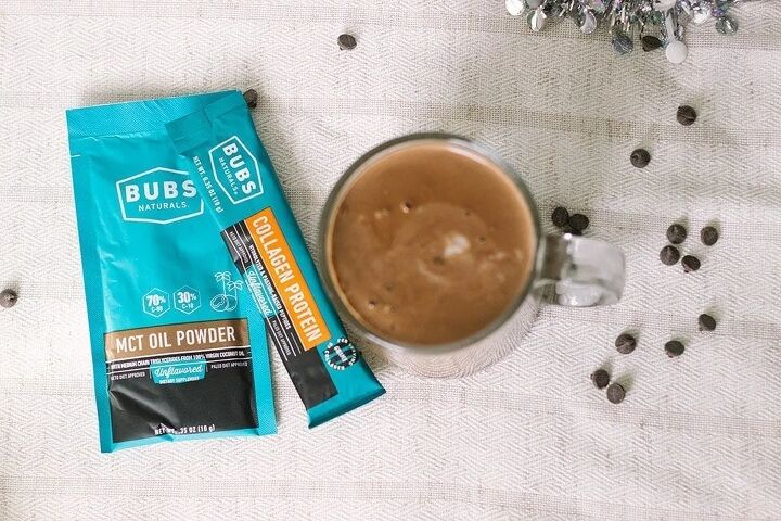 easy and delicious low carb hot chocolate recipe, Packets of BUBS next to a mug of keto hot chocolate
