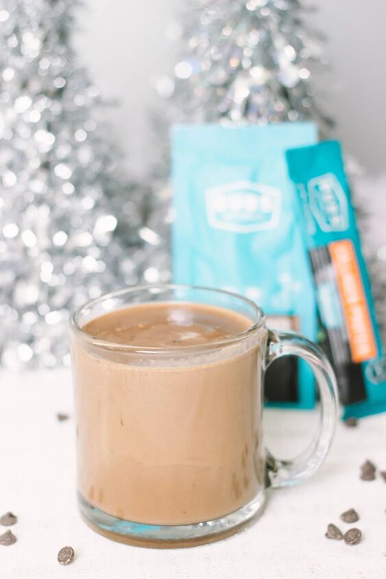easy and delicious low carb hot chocolate recipe, Mug of keto hot cocoa with blue packets in the back