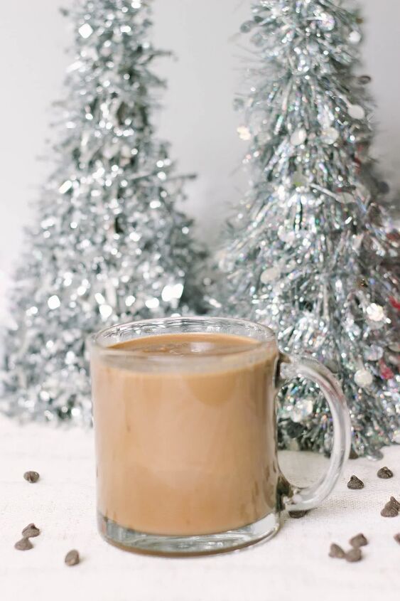 easy and delicious low carb hot chocolate recipe, Glass of low carb hot chocolate in front of silver Christmas trees
