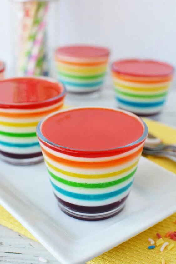 layered rainbow gelatin cups, Rainbow Jell o cups on a table