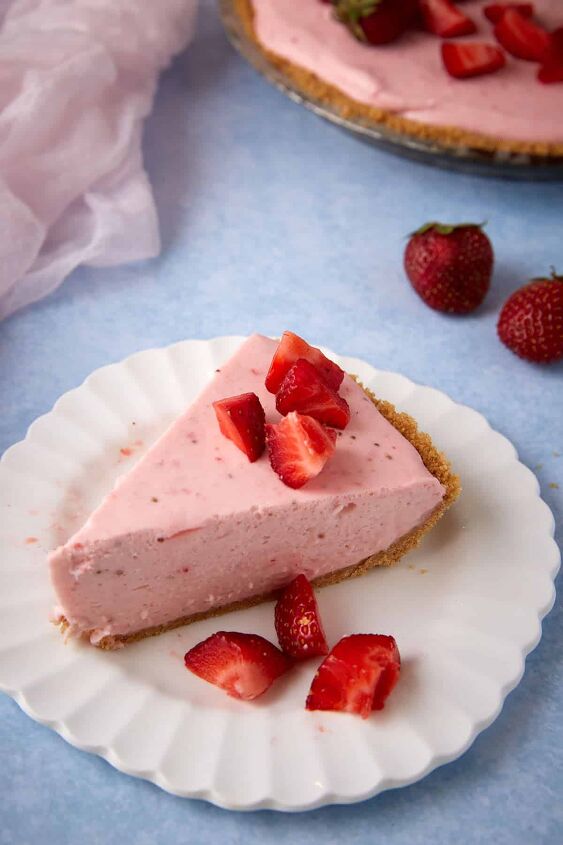 no bake strawberry cream cheese pie, A slice of strawberry cream cheese pie on a white plate
