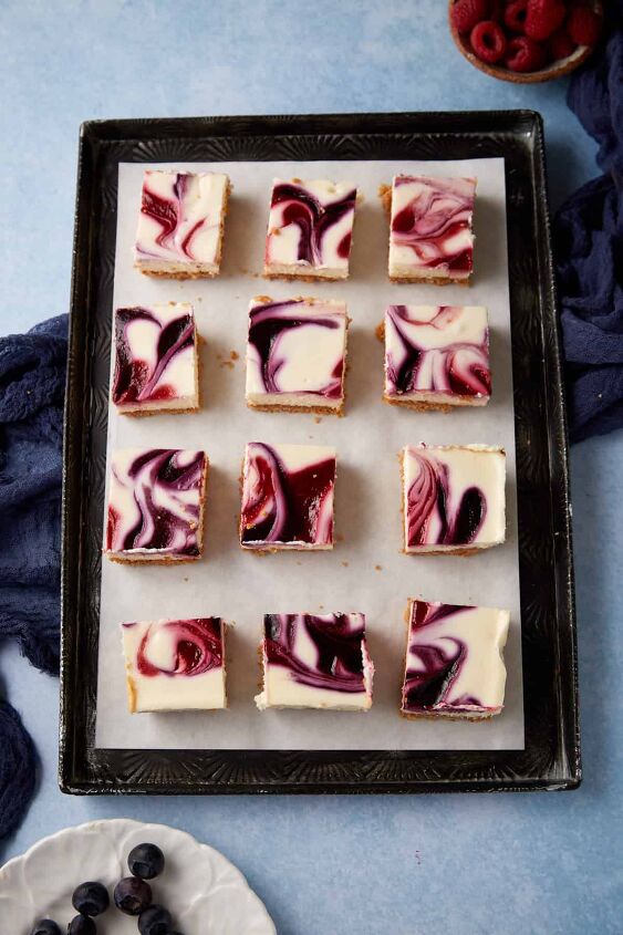 blueberry cream cheese squares, A batch of berry cheesecake squares on parchment paper
