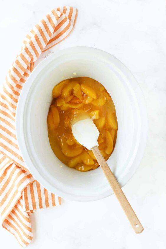 slow cooker peach cobbler, Canned peaches in a white slow cooker insert