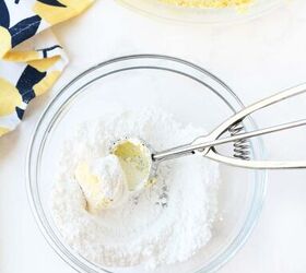 lemon cookies made with cool whip a perfect summer treat, A cookie scoop with dough in powdered sugar