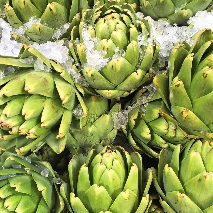 how to microwave an artichoke, A dozen fresh artichokes on ice at the market