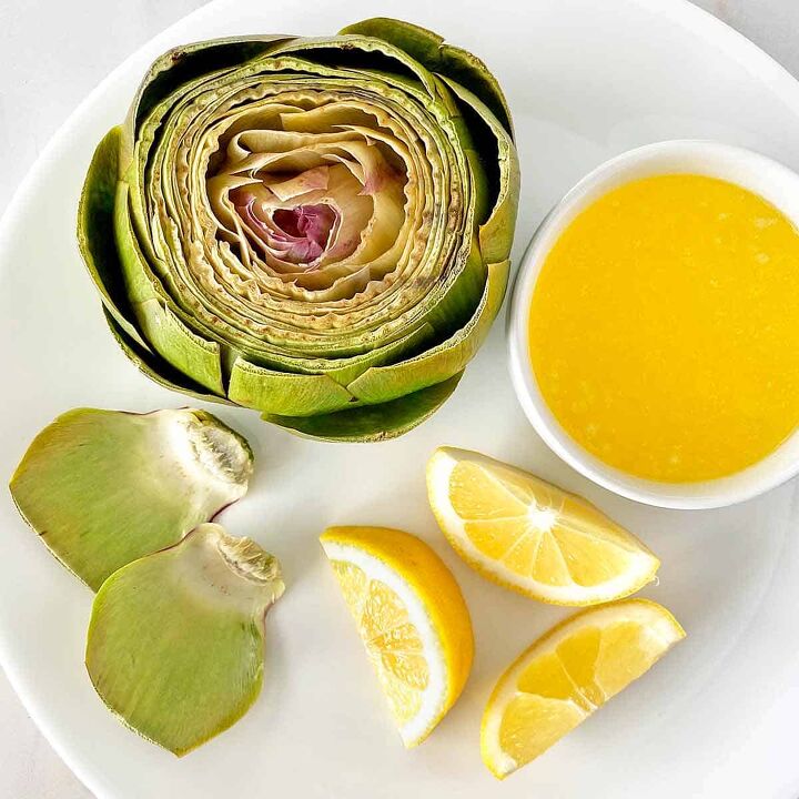 how to microwave an artichoke, A microwave steamed artichoke ready for serving with lemon wedges and melted butter