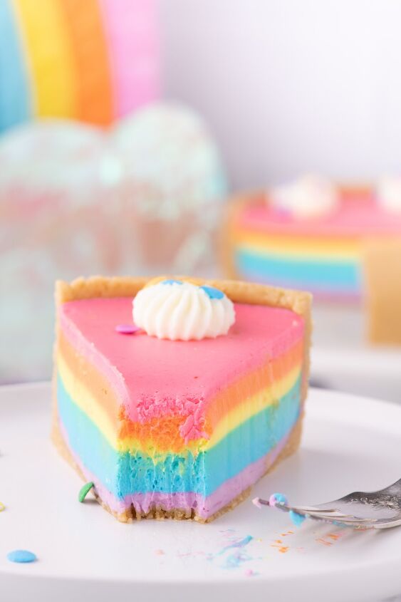 how to make a show stopping barbie no bake rainbow cheesecake, pretty rainbow cheesecake slice on a dish