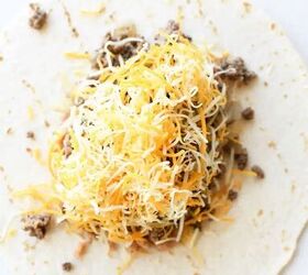 how to make beef chimichanga quick and easy, Open flour tortilla topped with ground beef refried beans and shredded cheese