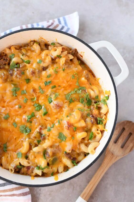 delicious ground beef chili mac cheese, Chili mac with melted cheese in a white Dutch oven