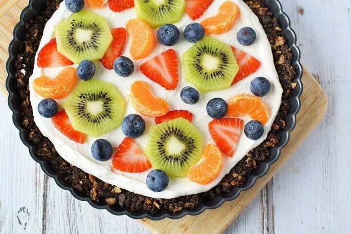 fresh fruit pizza dessert with ice cream cone crust, Overhead image of a fruit pizza on a board