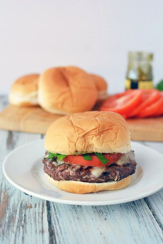 juicy grilled italian burger recipe, Burger with a bun on a plate topped with tomato and lettuce