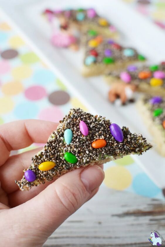 nutritious fairy bread, Holding a piece of bread that is covered in chia seeds and sunflower seeds