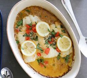 baked greek cod recipe gluten free, baked greek cod in a dish garnished with lemons and tomatoes