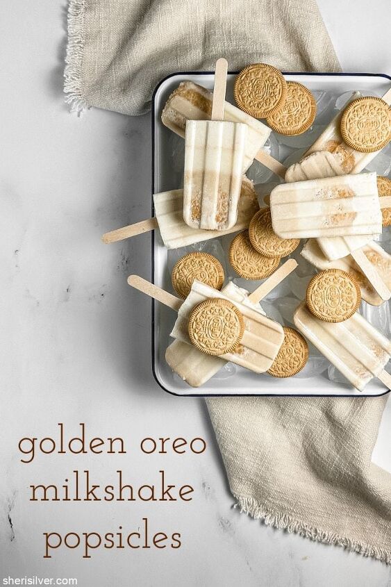 easy 4 ingredient golden oreo milkshake popsicles sheri silver, golden oreo milkshake pops in an enamel tray with golden oreos